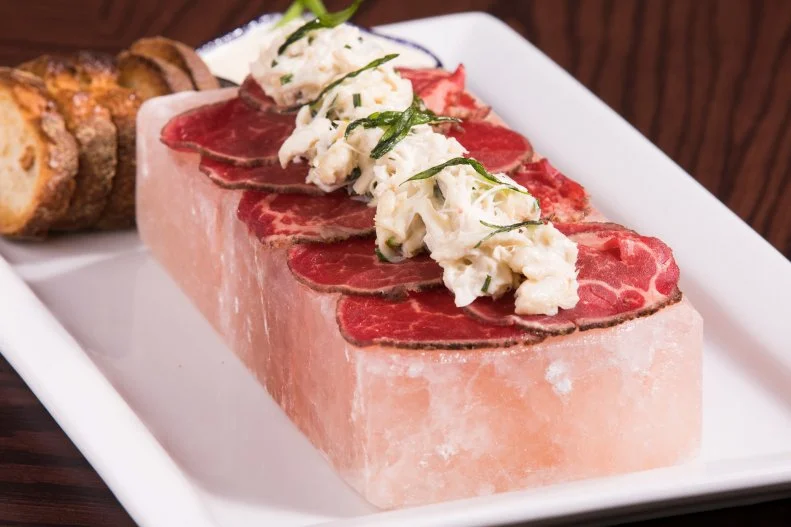 Flight Club's Surf and Turf Sashimi is listed only in the appetizer section of the menu, but it's rich enough that it deserves to be in a category of its own. Experience the raw flavor of wagyu beef, amplified by horseradish crema and yuzu crab salad, all served on top of a Himalayan salt block.