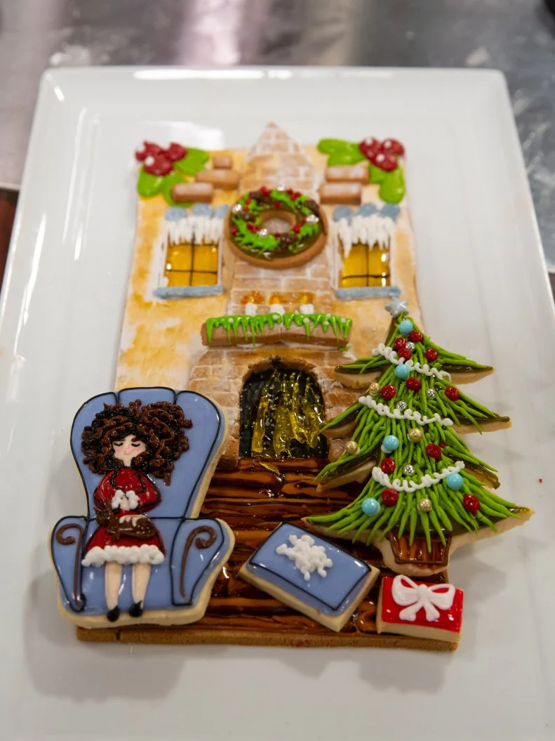 Baker Abby Tucker's R2 dish: DESIGN: A Christmas Fireside Nap COOKIE DOUGH 1: Vanilla Cookie.w/ Butterfly Pea Tea Glaze.COOKIE DOUGH 2: Ginger Orange Cookie w/ Vanilla Glaze & Royal Icing, as seen on Christmas Cookie Challenge, Season 5