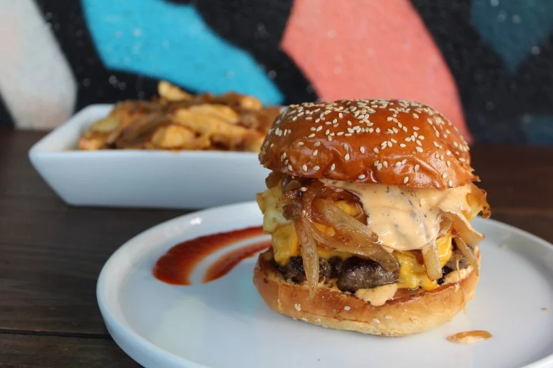 Beer Belly's offbeat gastropub menu and rotating craft-beer selection have increased the circumference of more than one Angeleno's waistline. The place is hailed for its upscale, belly-extending comfort fare like Death by Duck, duck-fat fries topped with crisp fried duck skin and succulent duck confit. That acclaimed dish is an ideal entry point for the Sriracha Beast Burger, which is slathered with spicy Sriracha Island dressing and topped with American cheese, griddled onions and fries, all housed inside a sesame brioche bun.