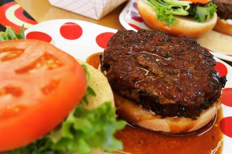 It should come as no surprise that a place as culturally diverse as Hawaii would have a delicious style of burger all its own. It's called the Teri Burger. Formerly called "barbecue" at old-style drive-ins, these local burgers are slathered in a sweet, shoyu-based sauce. Try one at comic book-themed Burgers and Things in Honolulu. The folks here serve their juicy patties dipped in a housemade teriyaki sauce on your choice of white, wheat, brioche or pretzel bun, with lettuce, tomatoes and balsamic aioli. On Tuesday through Friday from 3 to 5 p.m., it's offered with a small fries (or salad) and small drink for $10 as a happy hour special.