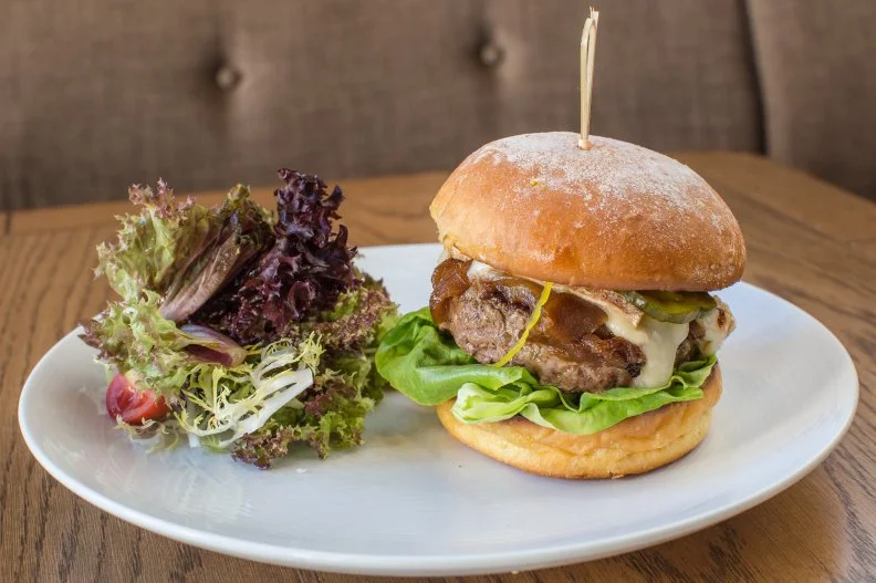 Since opening in June 2015, Nina Compton's Compère Lapin has received such high praise, from publications ranging from Eater to The New York Times, that it's hard to keep up with the acclaim. She even took home a James Beard Award for her impeccable Caribbean- and European-influenced Louisiana fare. It may not be the first dish that comes to mind here, but Compton's Wagyu Burger is another winner. Made with Louisiana wagyu beef and topped with sweet caramelized onion plus fruity, aromatic Taleggio cheese and bread-and-butter pickles, it perfectly encapsulates the Top Chef's sophisticated interpretations of classic dishes from around the globe.