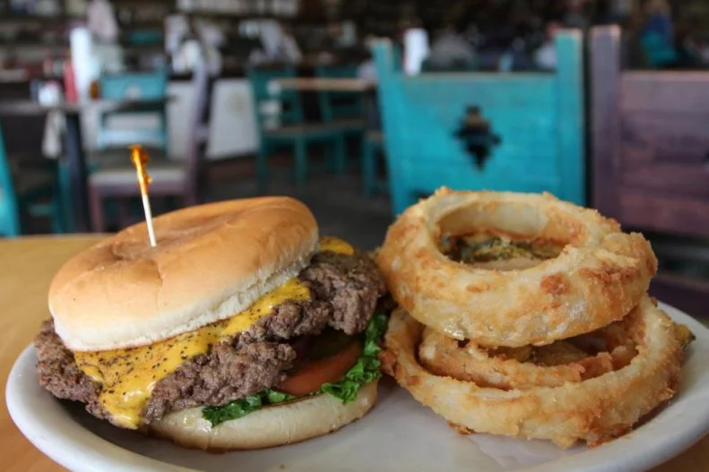 The Hubcap burger with onion rings and fried pickles at Cotham's Mercantile in Scott, Arkansas as included in Arkansas's Most Iconic Eats for FoodNetwork.com