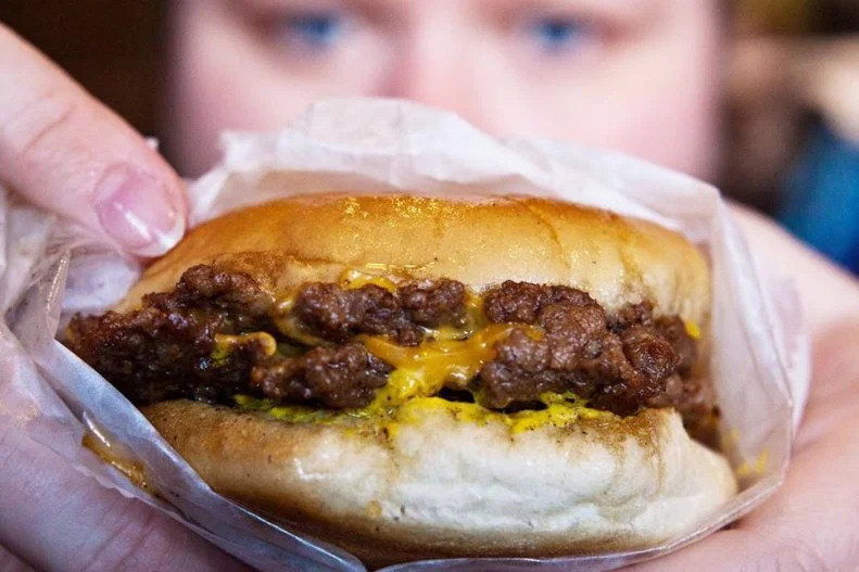 For more than a century, the folks at this Beale Street institution have been using the same vat of grease to fry their juicy burgers. That "Vitamin G," which is strained daily, is said to be responsible for creating the world's most-unique burger flavor. Up to 500 times per day, the cooks of Dyer's smash balls of ground beef flat and thin on the marble counter and drop them into huge cast-iron pans. Each patty sinks to the bottom of the oil while frying crisp and brown, then it floats to the top of the grease to be scooped out onto a bun that soaks up a little more of the delicious grease. Offered as a single, double or triple and with or without cheese, each one of these aromatic burgers gets topped with mustard, onion and a pickle â   but definitely no lettuce or tomato.