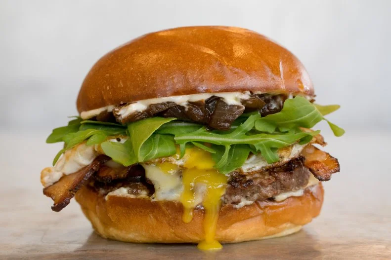 Founded by brothers Joel and Duncan Gottt in 1999, this Napa Valley joint offers a modern approach to American roadside cuisine with locally sourced ingredients for its fare and California-centric picks for its wine and beer. The California Burger epitomizes its fresh approach to fast food with a one-third-pound Niman Ranch beef patty topped with fried egg, Swiss cheese, Zoe's bacon, arugula, balsamic onions and mayonnaise on a toasted egg bun. This and all the other burgers and sandwiches on the menu can be customized with a lettuce wrap or gluten-free bun as well as your pick of veggie burger patty, Diestel Ranch turkey burger or an Impossible Burger patty (for a $4 upcharge) at seven Northern California locations.