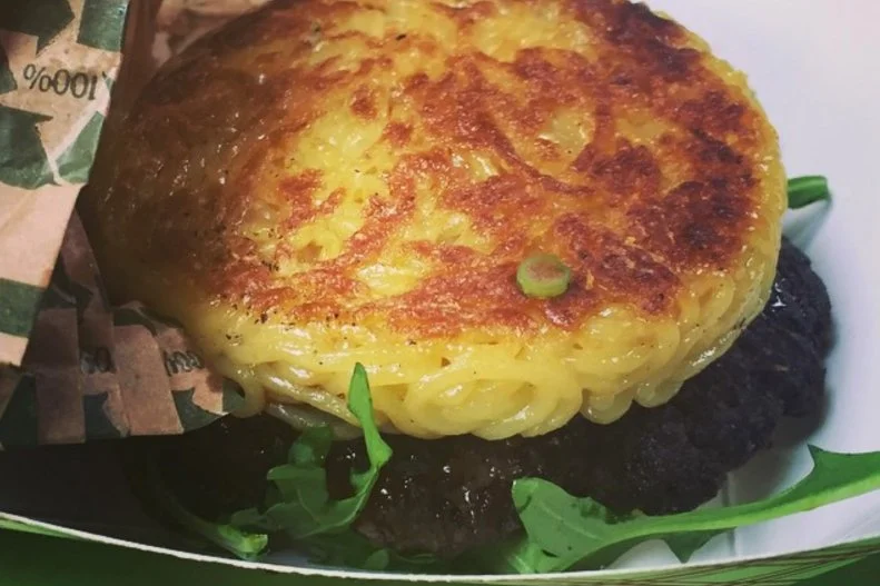 As a Japanese kid growing up in Los Angeles, Keizo Shimamoto spent a lot of time traveling back and forth between Tokyo and California, falling in love with both Japan's ramen culture and Southern California's impressive burger scene. Through his travels and ramen studies, he came up with what proved to be a brilliant idea: the ramen burger. Debuted at Williamsburg's Smorgasbord Market in 2013, Shimamoto's hybrid dish exploded into the international spotlight, spawning numerous imitators around the globe. Now a handful of variations are on the menu at his lauded Queens restaurant Ramen Shack, but you've got to try the Original "OG," which features a thin certified-Angus beef patty with arugula, scallions and a secret shoyu sauce held together by two springy homemade ramen buns.