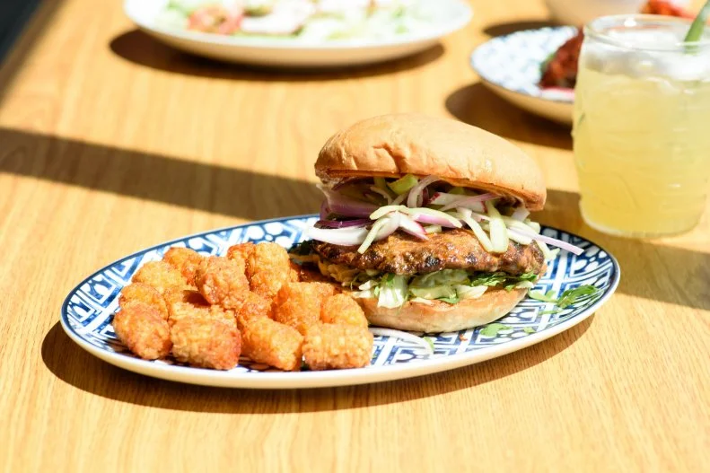 Rachel Cope owns some of the hottest restaurants in Oklahoma City. She's got a New York City-style slice shop, a buzzy ramen-ya and a daytime coffee shop that turns into a cocktail bar at night. But her tacos-and-tequila joint Revolución, housed in a former auto garage, is the place that serves one of the best new burgers in town. The Torta Burger features a chorizo-ground beef patty on a toasted bolillo roll with cucumber-radish slaw, shredded lettuce, cilantro and mole mayonnaise with a side of chile-dusted potato tots.