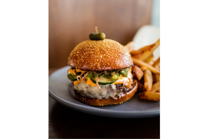 Restaurateur Gabriel Stulman has opened some of Manhattan's most-beloved neighborhood gems â   places like The Little Owl, Joseph Leonard and Bar Sardine. In no small feat, he's managed to bring that same cozy locals-only vibe to the Freehand Hotel with his living room-like Simon & the Whale. This upscale Gramercy Park restaurant offers solid American fare with lots of seafood and vibrant produce. Its lunchtime burger, available Monday through Friday from 11:30 a.m. to 2:30 p.m., is a prime example of the elevated cuisine, covered with Jack cheese, tomato aioli and crispy shallot and served with a side of fries.