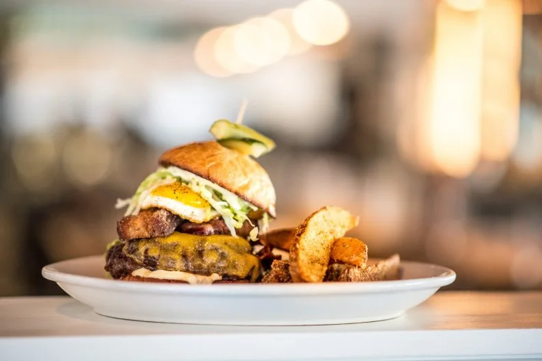 Chef Ryan Lowder's New American restaurant, The Copper Onion, is considered one of the buzziest restaurants in Salt Lake City. And his Copper Onion Burger, with grass-fed Niman Ranch beef, caramelized onion, cheddar, duck fat aioli and iceberg on a house brioche bun, is hailed as one of the best in town. In-the-know locals, however, opt for the restaurant's off-menu specialty. A variation of the already decadent regular burger, The Heart Stopper packs on the calories protein with crispy Ballard Farms pork belly, Niman Ranch applewood-smoked bacon and a fried Clifford Farms egg.