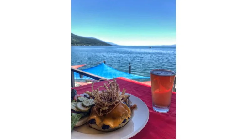 Accessible via car or boat, this Caribbean-inspired dockside restaurant and bar would make Jimmy Buffett swoon. It serves cheeseburgers (and margaritas) in paradise, overlooking the crystalline waters and Rocky Mountain backdrop of Flathead Lake. The Montana Beer Burger is the fan favorite. Half-pound beef patties are made in-house daily, cooked to order and topped with melted cheddar cheese, fried onions, and onions caramelized in Blackfoot Brewing IPA, made nearby in Helena. That flavorful, hops-infused combination is cradled in a locally made bun from Ceres Bakery and served with fresh-cut fries. It pairs impeccably with the Razzu! Raspberry Wheat beer from Philipsburg Brewing Company (pictured above), one of the dozen-plus local brews on the menu.