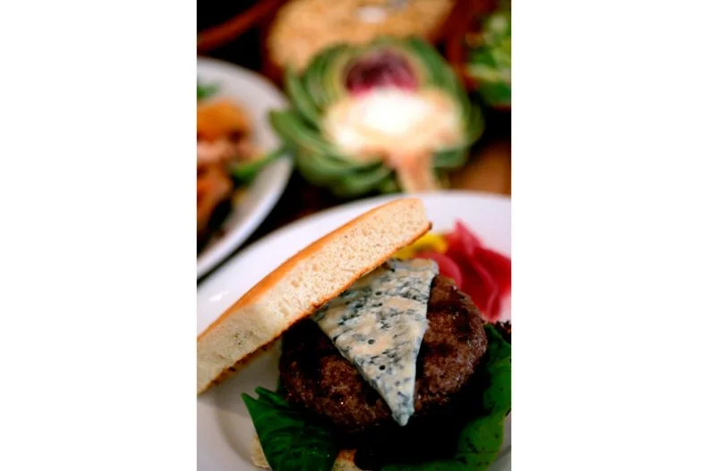 This James Beard Award-winning Hayes Valley stalwart has been hailed for sustainable, locally sourced Mediterranean fare since 1979. Its roast chicken is considered one of the must-try dishes in the Bay Area. So is its unique lunch-only burger. Medium-lean, grass-fed beef is finely ground in-house and cured with salt and pepper overnight to seal in juices, before being cooked to order over a mesquite grill. That flavorful patty is sandwiched between slices of grilled rosemary focaccia slathered with aioli and topped with Zuni pickles (house-pickled zucchini and onion strips). While it's pretty much perfect as is, guests can customize this upscale combination with their choice of fancy cheeses such as Bayley Hazen blue or Shelburne Farms cheddar.