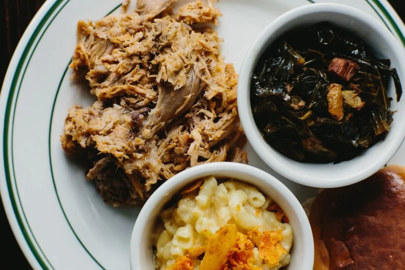 Whole hog is what you'll find in the eastern portion of the Tar Heel State. There, pitmasters like Sam Jones of Sam Jones BBQ in Winterville and Skylight Inn BBQ in Ayden smoke whole hogs over a pit, then chop up the meat, mixing white and dark together like a porcine yin-yang, and douse it with a white vinegar sauce simply seasoned with salt, pepper and red pepper flakes. There are lots of great places serving the specialty along the I-95 corridor, but over in Asheville, well beyond the North Carolina 'cue lines, James Beard nominee Elliott Moss is serving some of the best whole hog in the United States at Buxton Hall Barbecue. Set in one of the top tourist destinations in the state, it's a convenient place to sample whole-hog barbecue while soaking up the mountain views and ample craft brews in the Land of Sky.