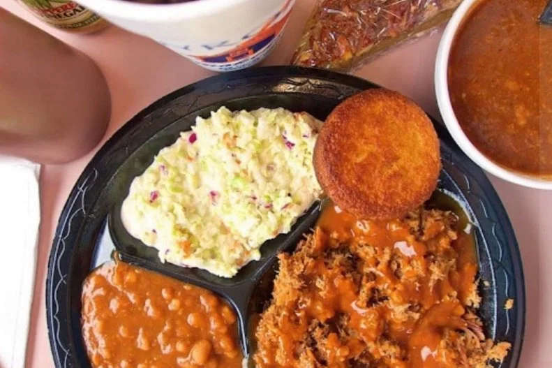 Just across the border from Georgia, Southeast Alabama shares some similarities with its neighbor. The dominant sauce is that mustard-based mix that's popular in nearby Columbus, and the meat is heavy on the smoke. At places like Byron's Smokehouse in Auburn, aromatic pork shoulder is served either chipped or chopped (Byron's does chipped or sliced) in platters or on sandwiches. Ribs are another local mainstay, served with a range of craveable sides that are worth a try even if you don't eat meat. The options usually include beans, slaw, mac 'n' cheese and different kinds of greens, followed by homemade pies for dessert.