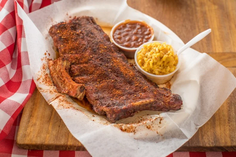 When most folks think Tennessee barbecue, they're probably thinking Memphis and, most likely, ribs. The Blues City's famous "dry" ribs, coated in a rub made of salt, garlic powder, oregano, paprika and other spices, were influenced by the city's large Greek population and were made famous by Charlie Vergos' Rendezvous before spreading around town. You'll also find "wet" ribs coated in the local vinegar-tomato-and-mustard sauce or "muddy" ribs with both wet and dry. There's a reason ribs and smaller cuts like slow-cooked Boston Butts are the favored proteins in this long-established city: The tight density of the urban environment forced pitmasters to move away from whole hogs that take up a lot of space and squirt out a lot of grease, a potential fire hazard with closely packed buildings.