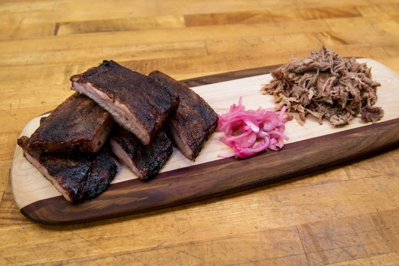 The state-sponsored South Carolina BBQ Trail map refers to "The Mountains" as the third official barbecue region in the state. In the hilly area surrounding Greenville, at places like Henry's Smokehouse, pink-hued tomato- and vinegar-based sauces are a popular condiment for smoked pork shoulder. Barbecue Lover's the Carolinas author Robert Moss disagrees with the official designation, saying there's been so much mixing and mingling throughout the state that South Carolina-style tomato-based sauce shouldn't be assigned to one particular geographic area. "It's really just everywhere else," he says. "There's not so much definition."