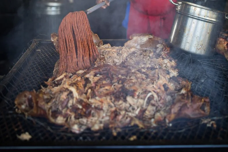 Close to what you'll find in eastern North Carolina, whole hog has seeped south of the border into the Pee Dee region of South Carolina. These whole beasts are slowly cooked over huge pits holding wood coals and topped with a spicy pepper-infused vinegar sauce. That's how the Scott family of Hemingway have been cooking their pigs for decades. But these days, 'cue lovers can stay in Charleston to enjoy Rodney Scott's Whole Hog Barbecue. The James Beard Award-winning pitmaster smokes his hogs belly down for 12 hours over a glowing mix of oak coals and hickory and pecan hardwood, then flips the beasts on their backs and liberally seasons the meat with his secret sauce. When it's sufficiently flavored, the meat is pulled and served on sandwiches and plates with sides like grits and cornbread.