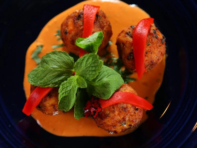 A plate of the Bolhinos de Batate Doce dish from Caf? Brazil in Denver, CO, as seen on Food Network's Diners, Drive-Ins and Dives, Season 23.