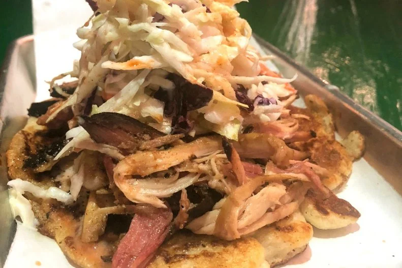 The Nashville tradition of serving pulled pork atop a hoecake is what inspired Western Tennessee whole-hog lover and pitmaster Pat Martin to create the Redneck Taco at Martin's Bar-B-Que Joint. His version essentially features a cornbread pancake topped with slaw, sauce and choice of meat (whole hog, brisket, sausage, chicken, turkey or catfish). While Martin's acclaimed restaurants' riff on the classic with varying slow-smoked proteins and his signature whole hog, Nashville's traditional barbecue norm features smoked pork shoulder coated with a sweet vinegar-based sauce.