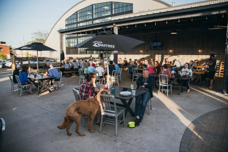 This industrial-chic Oakley brewery and taproom is a favorite local hangout. The place features a large bar with knowledgeable staff, open ceilings, rustic wood accents and a dog-friendly beer garden outside with a separate entrance off to the side. Pets are always welcome in the garden, which is tented and heated during the cold months, while you sip house brews like Dreamsicle Kolsh, Blackberry Farm Classic Saison and Boone Barley Wine. Delicious wood-fired pies are provided by Catch-A-Fire Pizza's on-site cafe that offers 15 specialty pizzas like the Three Little Pigs with Italian sausage, pepperoni and prosciutto, and breakfast pies on the weekends.