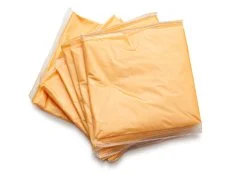 Sliced cheese in foil isolated on whit