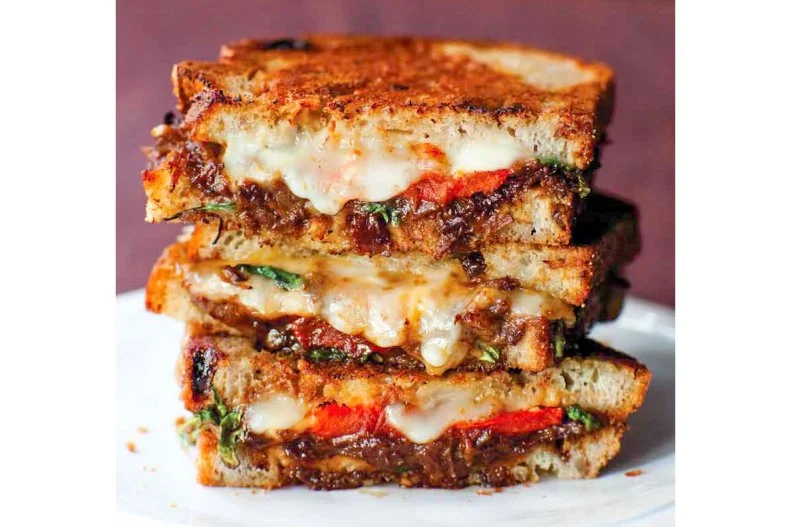 The winner of LA's Grilled Cheese Invitational, this sandwich takes all the elements of a cheese plate and turns them into one over-the-top sandwich. The grilled cheese is made with Taleggio cheese on raisin walnut bread. It's spread with a sweet and salty apricot-caper spread (made in-house) and topped with sun-dried tomatoes and arugula. Meat lovers can add short ribs for extreme decadence.