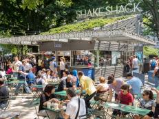 New York City, USA - June 9, 2013: People dining at Shake Shack in Madison Square Park. This image shows New Yorkers and tourists having lunch at the original (first) Shake Shack in New York City.