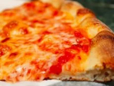 Found on nearly every street corner in the city and most pizzerias throughout the United States, New York's thin, gas-cooked rounds are what many Americans think of when they think of pizza. These classic pies and individual slices are both crisp and chewy, ideal for folding in half and gobbling up on the go. Grab one at Joe's Pizza in Greenwich Village. The small shop moved a couple of blocks from its original location in 2005 and has debuted three additional outposts, but it still serves the same iconic slices with bright sauce and gooey cheese that it has since 1975, at just $3 a pop.
