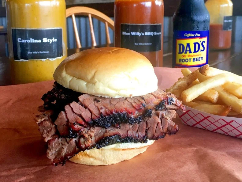 At nine years old, Will Banks started smoking meat at his grandfather’s Elgin, Texas, butcher shop and barbecue joint. When Banks was 15, his grandfather sold the business and the family relocated to New York City, but neighbors could still smell wood-smoked brisket aromas wafting from their Queens backyard. After a long stint in the corporate world, Banks has followed in his grandfather’s footsteps, opening an old-school Texas barbecue joint in Oakland Park. Juicy brisket, chewy spare ribs and bold Kreuz Market Texas jalapeno-cheese sausages are served on butcher paper just as you’d find in the Lone Star State. Lines of patrons snake well beyond the door nearly every day of the week, but the crowds are particularly large on Thursdays, when Banks makes peppercorn-crusted smoked pastrami, piled high on a onion bun with coleslaw and a side of grainy mustard.