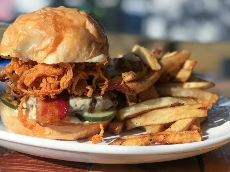 Asheville has long been a renowned beer scene. One of the foremost places to try the local brews is Bhramari Brewing Company, where several popular burgers can be paired with various beers brewed right on site or nearby. Their signature burger is the perfect place to start, with grain-fed beef, a stout glaze, crispy onions, oaked mayo, pickles, hop-smoked truffle cheese and two thick slices of candied bacon. Order their Molly's Lips black gose or ask the staff for another perfect pairing.