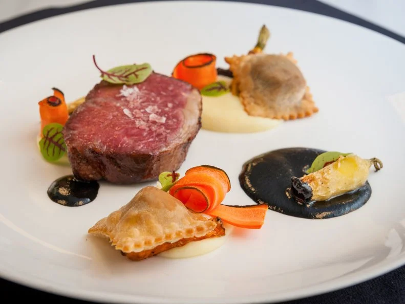 Set on an 8,000-acre estate that was originally the private home of the Vanderbilt family in the late 19th century, the elegant Dining Room at The Inn on Biltmore Estate offers seasonal dishes in a setting with white tablecloths, mountain views and gracious service. Chef Sean Eckman uses produce from Biltmore's own farm in global preparations with grand style. Filet mignon is a nod to the estate's agricultural roots and current farm practices, often prepared using beef from the estate's herd. George Vanderbilt would likely have been as proud to serve his guests from this menu as Biltmore's culinary team is today.