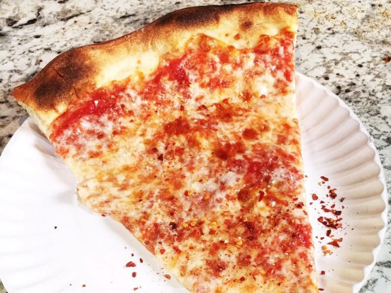 Most of New York's pre-eminent pizza parlors are actually better associated with whole pies; Joe's, however, is the rare spot enthusiastically devoted to a great slice. Cooked on gas decks instead of in fancy wood-fired ovens, the thin-crusted, gold-standard pies are made the same way -- and with the same ingredients -- as when Pino "Joe" Pozzuoli opened his Greenwich Village flagship in 1975. And though it's spawned three more locations since then, city-dwellers know that Joe's is still one of the most-satisfying and reliable places to burn $2.75.