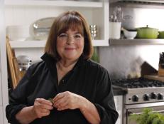 Host Ina Garten in the kitchen about to sprinkle dill on the smoked salmon platter, as seen on Food Network's Barefoot Contessa: Back to Basics, Season 12.
