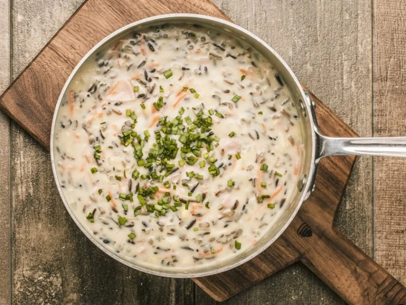 Wild Rice, which is not actually rice at all, but grass seed, is Minnesotaâ  s state grain and one thatâ  s been lovingly embraced by Minnesotan cooks. You find it in everything from burgers, pancakes, hot dish and of course, the famous Minnesota wild rice soup. While you can find this soup, both creamy and brothy, on restaurant menus all over the state, the version Minnesotans love best, canâ  t be found at any of the stateâ  s dining establishments. You can buy it by the cup or the quart at Lunds & Byerlys grocery stores. This upscale chain, which has been in the Twin Cities for generations, has a loyal following when it comes to its iconic soup. Rich, creamy and comforting, the  soup is studded with chunks of ham, loads of wild rice, veggies and crunchy almond slices. You can take it to go, or enjoy it in one of their in-store cafes.