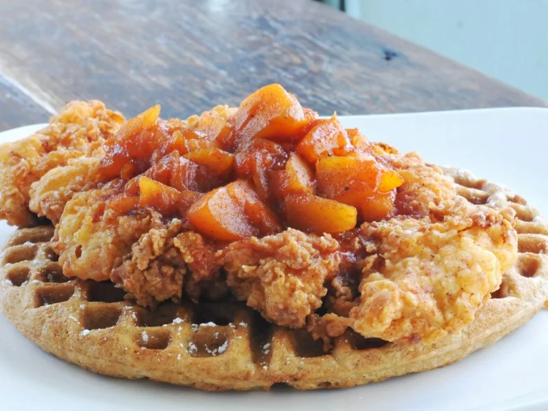Housed inside a brick-walled building in Atlanta’s Inman Park, Folk Art Restaurant dishes up elevated Southern fare with a side of downhome comfort. Chefs blend sweet potato into a buttermilk batter, forming a waffle base for combinations like peanut butter-banana, chocolate s’mores and the aptly-named Foul Play, which pairs a waffle with succulent fried chicken and peach compote made with Georgia fruit and — since it is in the South — a generous pour of Clyde May’s whiskey.