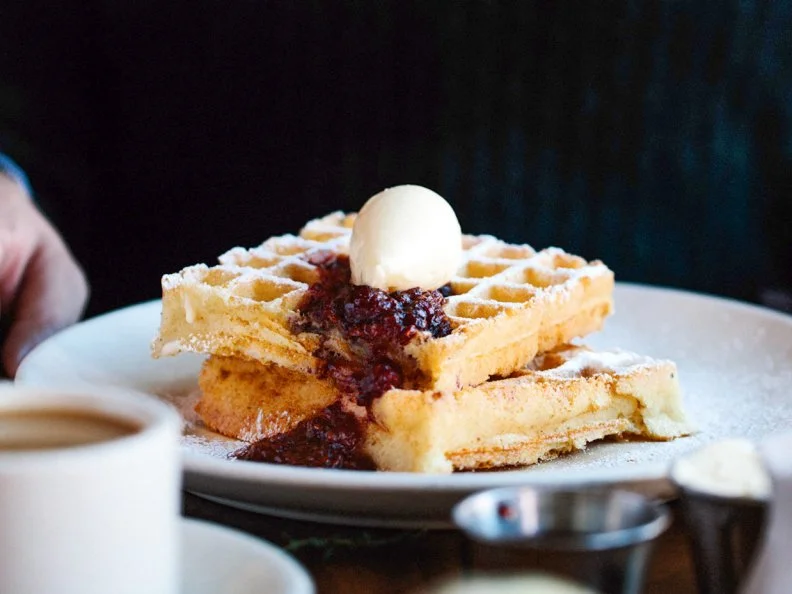 Other dishes at cult-beloved The Publican have come and gone, but the Belgian waffle has been a brunch menu staple since the award-winning beer hall debuted in 2008. Cooked in a seasoned cast iron maker imported from Belgium, the waffle is as delicious as it is simple â   each fluffy square is only accompanied by a hefty pat of housemade honey butter and seasonal preserves. Diners can also add ice cream when ordering the waffle for dessert.