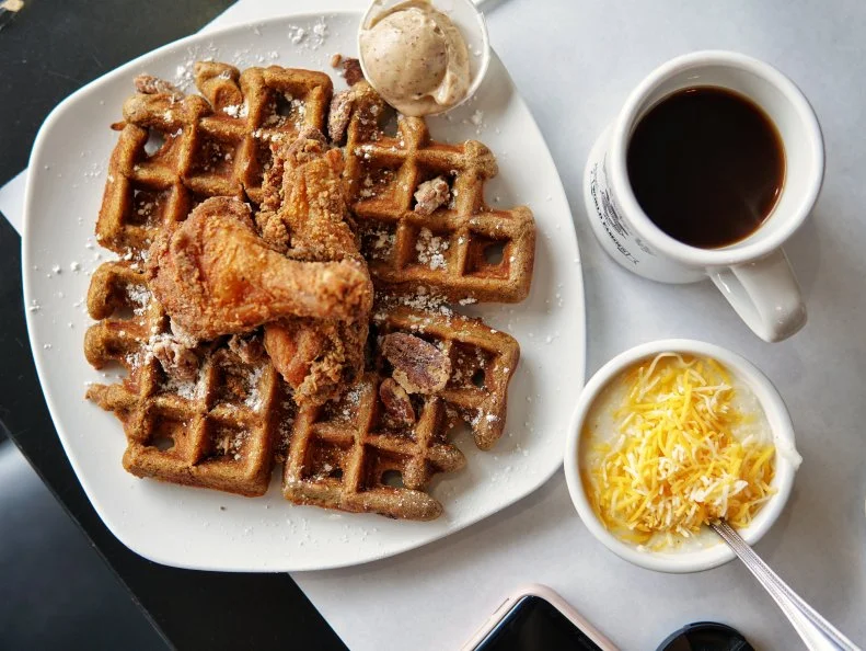 Damien ‘Dame’ Moore and Randy Wadsworth may humbly use the tagline “Almost World Famous” to describe their fried chicken and waffles, but the crowd that gathers outside Dame’s three outposts proves that the signature Dame’s dish has serious star power. Each of the menu’s takes on the iconic American meal — with tongue-in-cheek monikers like the Carolina Cockerel and Frizzled Fowl — starts with three components: chicken, waffle and shmear, a flavored butter that they claim will make diners forget the syrup. Waffles are available in five different flavors, each one fluffy, craggy-edged and as good as the one before it, with a vegan option.