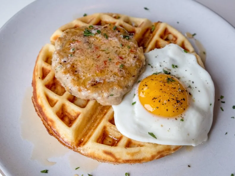 Originally conceived as a private events offshoot for its sister restaurant, Jeffrey’s, the charming Josephine House has established its own powerhouse reputation in Austin. Sophisticated spins on brunch basics make Josephine House , which is adorably situated in a converted house, a dining destination on weekends. Start with baked goods, like a Nutella morning bun, then move onto waffles. For its variation on chicken and waffles, the restaurant swaps the fried stuff for herb-flecked chicken sausages. The snappy links — ground in-house using thighs from Dewberry Hills Farm — sit atop a crispy yeast-leavened waffle with a fried egg, fresno pepper butter and maple syrup. It’s sweet, salty, spicy homespun flavor with every bite.