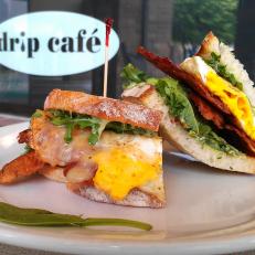 By working with local farmers who favor sustainable agricultural practices, Drip Cafe is on a mission to foster a stronger link between the community and the sprawling farmland surrounding Hockessin. Customers can feel good knowing the ingredients on their breakfast sandwich are hyper-fresh and responsibly sourced. The Cali, a nod to organic-obsessed West Coasters, features a fried egg, mozzarella, avocado, arugula and basil aioli on sourdough toast. Craving something meatier? You need the Brunch Burger, an eight-ounce beef patty served on grilled sourdough along with smoked bacon, fried onions, sliced tomato, green chiles, smoked gouda and an over-medium egg.http://dripcafede.com/menus/breakfast/