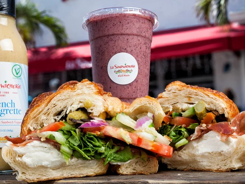 Since 1988, this quick-serve sandwich shop has fueled South Beach partygoers with French bread from Le Chic Bakery and all kinds of Eurocentric toppings like Camembert and saucisson. In fact, the popularity of these French-influenced creations led to the opening of a second shop amid the glittering business towers and luxury condos of Miami’s financial district in 2011. When breakfast service starts at 7 a.m., locals converge — possibly straight from nearby nightclubs — for flaky croissant sandwiches filled with egg and melted mozzarella. The hot croques, either with roast beef or smoked salmon, are excellent, too. 
http://www.lasandwicherie.com