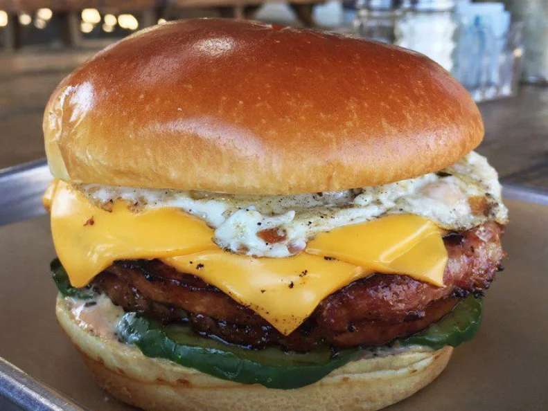 Pig & Pint is known first and foremost as a destination for first-rate barbecue, but itâ  s also the site of Mississippiâ  s best breakfast sandwich. Located in the historic Fondren District, the laidback gastropub has dozens of local, domestic and imported beers to pair with its comfort food. Stop by when the restaurant opens at 11 a.m. for the incredible Fried Bologna Sandwich, thick-cut housemade bologna on a golden brioche bun, with an over-easy fried egg, American cheese, specialty â  comebackâ   dressing and bread and butter pickles. Since this is a barbecue joint, the sides are also awesome, including smoked tomato coleslaw. http://pigandpint.com/eat-in-carry-out/#sandwiches