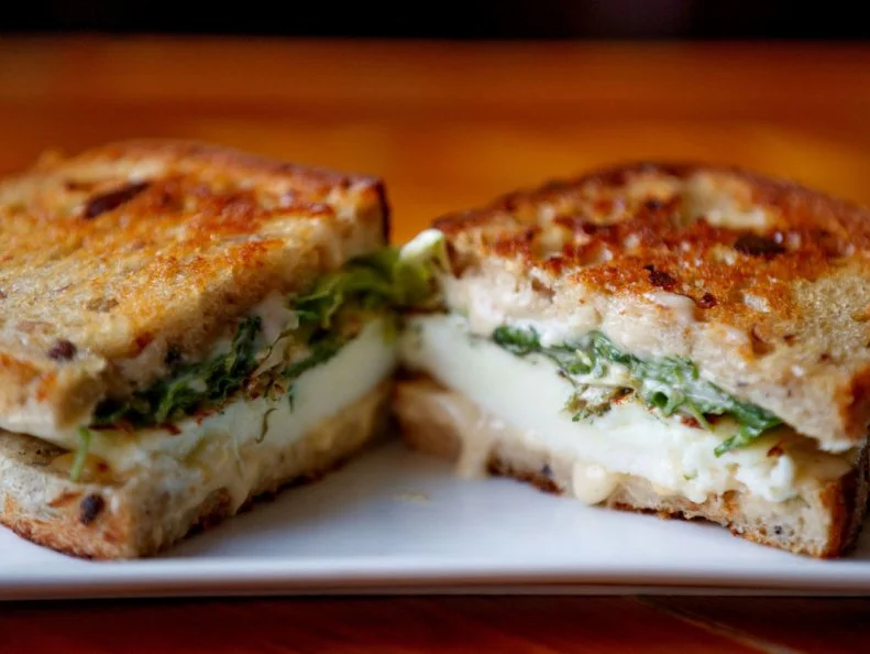 The first person who built a breakfast sandwich using cornbread was a genius. Though Culprit might not have been the first (Who can really be sure?), the fruits of this discovery are on full display at the quaint Omaha cafe. Exhibit A: The Egg White Sandwich. A far cry from diet food, silky egg whites are drenched in Mornay sauce and stuffed between two slices of blue cornbread, along with fresh dill and greens. The Whole Egg Sandwich â   frittata, smoked fontina and grilled ham or bacon on brioche â   is another customer favorite. Owner Luke Mabie handles the bakery and all things sweet; heâ  s also the mastermind behind Culpritâ  s blue cornbread. After a few years of operation, Mabie decided to bring in Chef Ben Jordan, formerly of Le Bouillon, to manage the savory side of things, launching Culprit Cafe from a quiet coffee hub to a full-blown brunch destination.http://www.culpritcafe.com