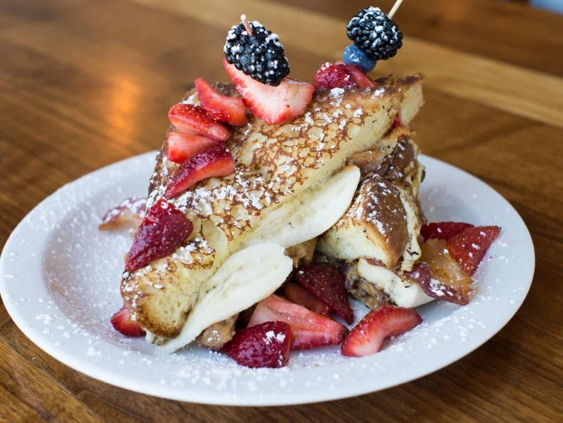 Located just a poker chip’s throw from the Burlesque Hall of Fame, this Arts District gem pays homage to Sin City’s most-notorious performer with one zany breakfast creation. The Fat Elvis offers up all of The King’s favorite sandwich ingredients — bacon, bananas and peanut butter — with the addition of Nutella and fresh strawberries. The bread? Two slabs of griddled French toast. For anyone skeptical of this incredible flavor bomb, try the equally satisfying B.L.T.A.E. It has all of the standard B.L.T. components, plus avocado, a sunny-side-up egg, basil pesto and mayo on grilled brioche.
http://mtocafe.com/downtown-mto-menu/#/