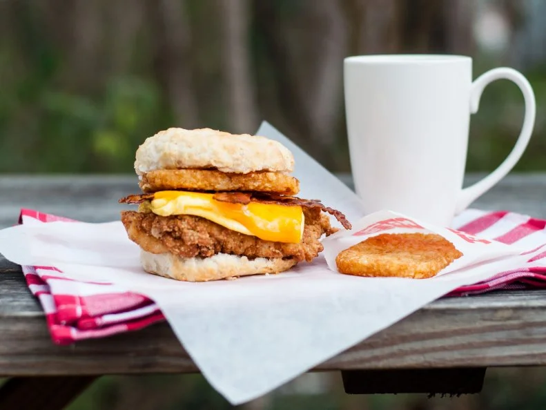 You donâ  t even need to leave your car to procure the biggest, fluffiest biscuits North Carolina has to offer. This award-winning drive-through Sunrise Biscuit Kitchen has two locations, in Louisburg and Chapel Hill. Owner Dave Allen credits his grandmother for the biscuit recipe. According to Allen, â  Her biscuits helped give her the stamina to give birth to 17 children and live to almost 100.â   Take that, kale. So, whatâ  s the best thing to order with them? Hands down, the fried chicken breast with bacon, eggs and cheese. Hereâ  s a pro tip: Order a side of hash browns, slip it out of its paper pouch and slide it right in there between the bacon and the top biscuit for an extra element of crunch.   http://sunrisebiscuits.com/our-menus.html