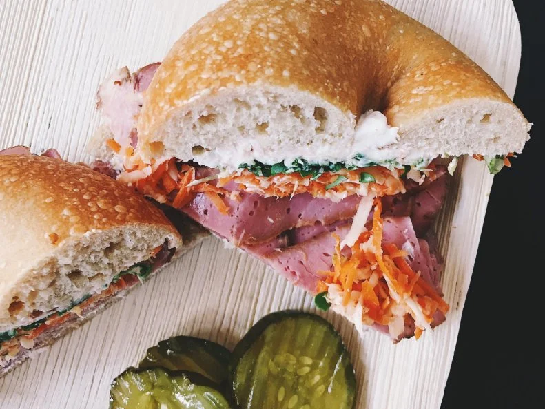 Hidden inside a mid-century antique furniture shop, this Scandinavian-Jewish fusion bagel concept brings a taste of old New York to Fargo, North Dakota. Modeled after the cozy lunch counters of NYCâ  s Lower East Side, BernBaumâ  s abides by the New York bagel method, too: They start their sourdough during the day, shape it in the evening and let it cool and ferment overnight. The next morning, the bagels are boiled, baked and served fresh with toppings such as Icelandic lox, pickled onions, fennel, cucumber, capers and chÃ¨vre cream cheese. The initial idea for the cafe began to germinate when husband-and-wife team Brett Bernath and Andrea Baumgardner realized they werenâ  t utilizing all of the space that their furniture shop afforded. Both had previous food industry work experience, so they mashed up their surnames and BernBaumâ  s was born. Another similarity to New Yorkâ  s bagel shop culture: BernBaum's seats just 17, so be prepared to take yours to go.   https://www.facebook.com/BernBaums/