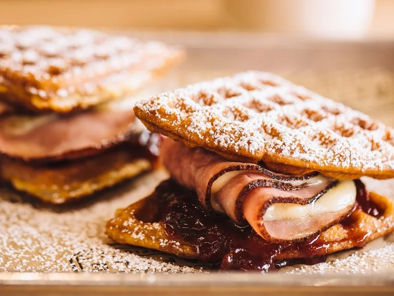 What could a waffle joint possibly know about breakfast sandwiches? Quite a bit, at least at OKCâ  s Waffle Champion, which wrapsg bacon, eggs and cheese in hot, buttery waffles for a new spin on the savory-meets-sweet breakfast concept. Diners are given a choice between a classic buttermilk waffle breakfast wraps and a sweeter Belgian-style option, which is used in the restaurantâ  s open-faced creations. Fillings run the gamut from fried buttermilk chicken tenders with crispy leeks and Tabasco honey to your standard egg scramble with bacon and cheese. For a one-of-a-kind breakfast experience, go for the Monte Cristo. Itâ  s smoked ham, Gruyere and strawberry-anise compote served between two of the classic buttermilk waffles.