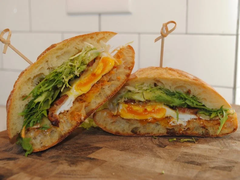 Supporting other Rhode Island businesses is a huge priority for this beachy cafe, which sources all of its ingredients from local purveyors. Plan a visit for gourmet coffee drinks, inventive cocktails and an impressive raw bar. Locals will tell you that the eponymous 10 sandwiches are the biggest reason to become a regular. Order the number three off the breakfast sandwich menu; it’s “soupy” — local-speak for soppressata — and prosciutto with a farm egg, fresh mozzarella, basil and red onion on ciabatta. The shop is just a stone’s throw from Watch Hill Cove, meaning there’s no better place to stop for a breakfast sammy to tuck in your picnic basket before a long day of soaking up the sun. 
http://www.tensandwiches.com/morning/