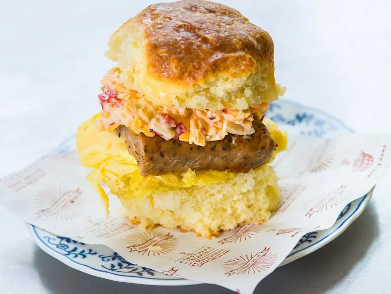 Anyone living in or around Charleston will tell you thereâ  s just one place to go for a quintessential Southern breakfast sandwich: Callieâ  s. Owner and creator Carrie Money and her team of expert biscuit bakers are responsible for churning out a million of their signature cream cheese-laced biscuits each year by hand. The single-concept joint offers its biscuits with essential Southern breakfast toppings, like country ham, black-pepper bacon and Carolina honey. Not up to the task of creating your own? Donâ  t worry: Carrie has you covered with one of her own creations, sausage, egg and pimento cheese on a biscuit. And, if you happen to miss standard breakfast hours, donâ  t fret. Callieâ  s stays open until 2 p.m. on the weekdays; the shop even does late-night service on Saturdays and Sundays from 10 p.m. until 2 a.m.http://calliesbiscuits.com/hot-little-biscuit/