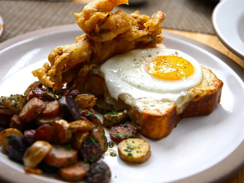 True to the Southern culinary ethos that launched the original Charleston location of Husk to super stardom, the Tennessee sister restaurant attracts customers with its low-country classics like chicken-fried steak and eggs smothered in white gravy. Serving only the freshest fare from regional producers, the restaurant changes its menu almost daily. But you can almost always count on some variation of a breakfast sandwich, whenever you stop by. Past offerings have included a fried soft-shell crab Monte Cristo and a build-your-own-breakfast-sandwich platter featuring black-pepper biscuits, dijonnaise, pickles and 24-month-aged country ham.
http://huskrestaurant.com/brunch/