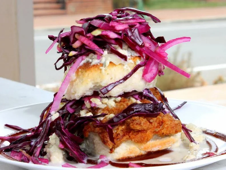 Home-cooked Southern staples like shrimp and grits and fried green tomatoes dominate the menu at this cozy Richmond bakery and cafe. Roll up your sleeves for the signature biscuit sandwiches, because even a fork and knife canâ  t save you from the delicious toppling mess the kitchen creates. First, thereâ  s the Got Your Goat, a sweet-and-savory sandwich consisting of fried chicken, pepper jelly, a mound of soft goat cheese and a sweet balsamic reduction. But despite the restaurantâ  s Southern roots, their most-popular breakfast order pays homage to the Big Apple, both in name and in grandiosity. Itâ  s fried chicken smothered with apple butter barbecue sauce, Granny Smith slaw and house made bleu cheese vinaigrette, all sandwiched between biscuit halves. Itâ  s edible Southern hospitality.https://www.fancybiscuitrva.com/menu