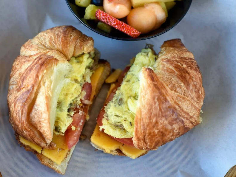 This husband-and-wife-owned American cafÃ© is only open for breakfast and lunch, but itâ  s a local favorite, especially on warm days, when locals grab a spot on the patio. to eat the Croissant Sandwich. Choose from ham, bacon or the homemade green chile turkey sausage, with eggs, cheese and tomatoes on a flaky croissant.http://www.cafelushabq.com/