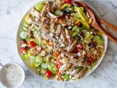 Chicken marinated in a tangy feta and herb vinaigrette is the star of this Greek salad chock full of veggies and topped with crispy pita chips.
